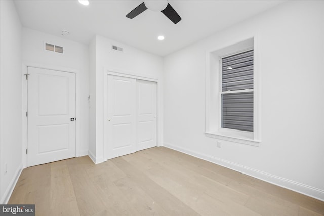 unfurnished bedroom featuring recessed lighting, visible vents, a closet, and light wood-style flooring