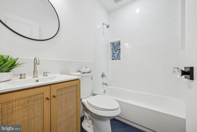 bathroom with tile patterned flooring, tile walls, toilet, shower / bathtub combination, and vanity