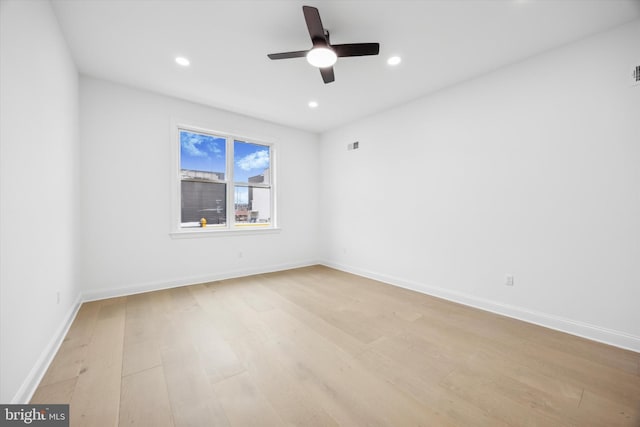 spare room featuring light wood-style flooring, recessed lighting, baseboards, and ceiling fan