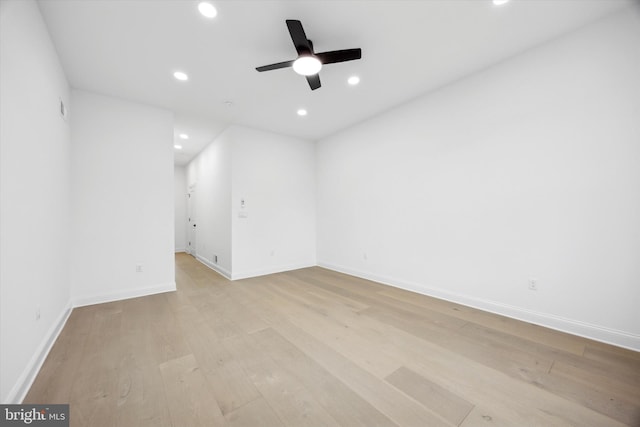 spare room featuring light wood-style flooring, recessed lighting, baseboards, and ceiling fan