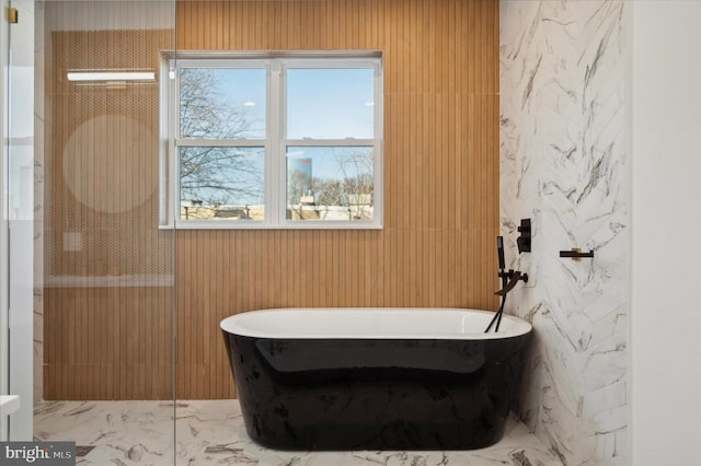 bathroom with a tub to relax in