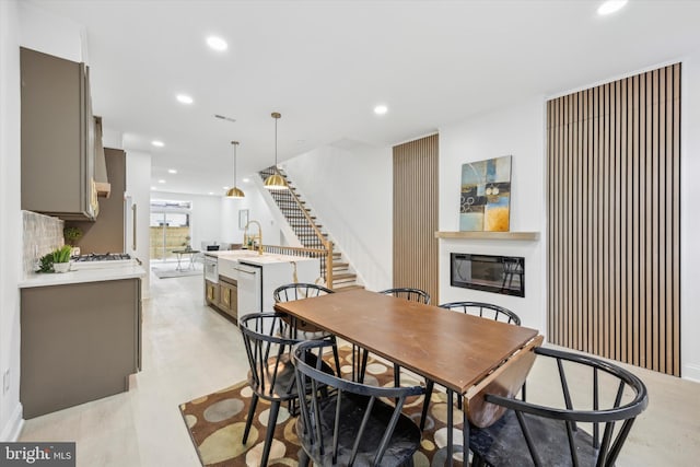 dining area featuring stairway, recessed lighting, visible vents, and a glass covered fireplace