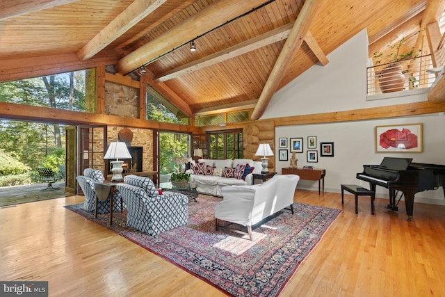 living area with wooden ceiling, high vaulted ceiling, beamed ceiling, and plenty of natural light