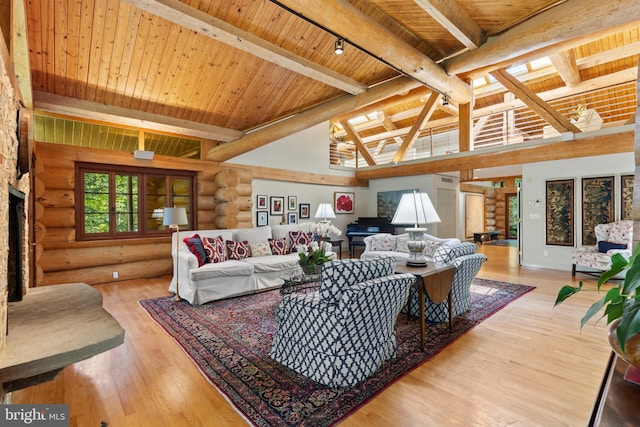 living area with lofted ceiling with beams, rustic walls, a fireplace, wood ceiling, and wood finished floors