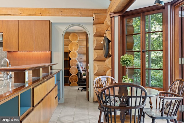 interior space with log walls and a wealth of natural light