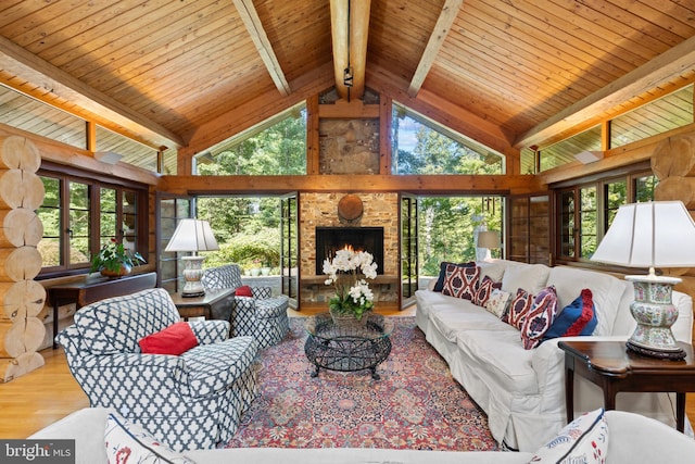 living area featuring beamed ceiling, high vaulted ceiling, wooden ceiling, and wood finished floors