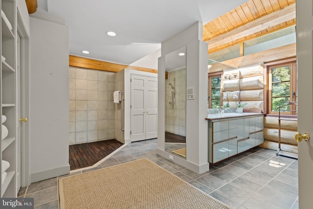 full bathroom with tile patterned floors, recessed lighting, tile walls, and a stall shower