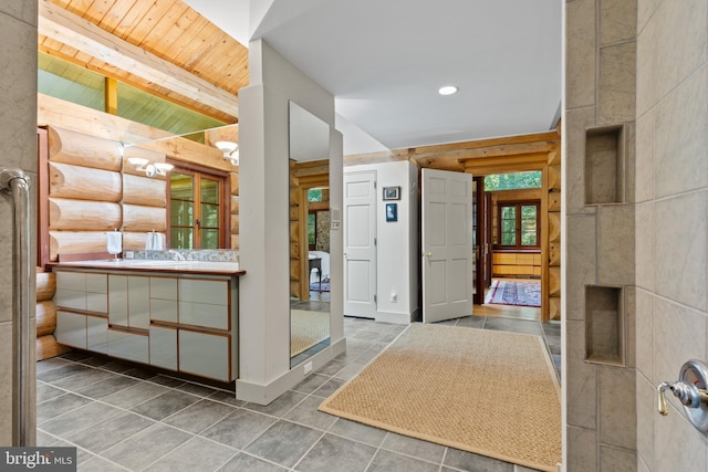 tiled entrance foyer featuring log walls, a sink, wood ceiling, beam ceiling, and recessed lighting