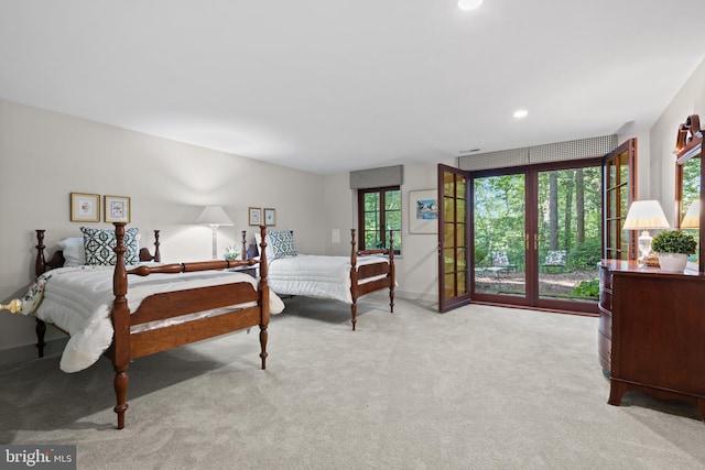 carpeted bedroom featuring access to exterior and recessed lighting