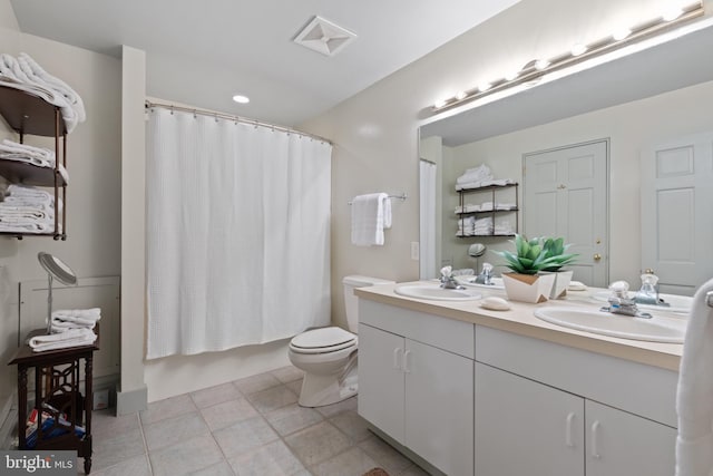 full bath featuring double vanity, visible vents, a sink, and toilet