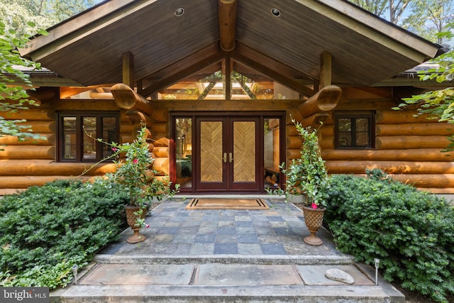 entrance to property with log siding and french doors