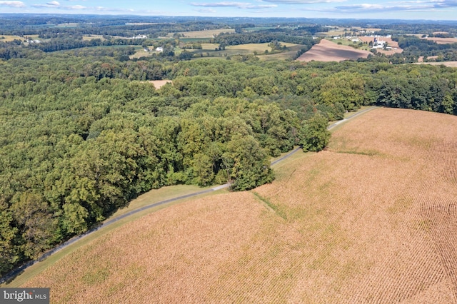 drone / aerial view featuring a wooded view