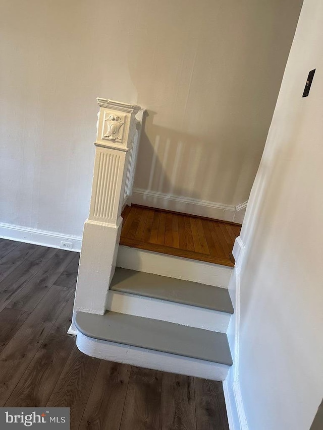 stairway with hardwood / wood-style flooring