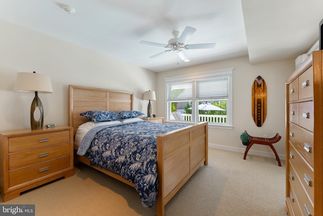 bedroom featuring light colored carpet and ceiling fan