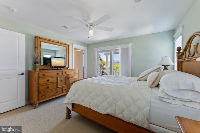 bedroom with access to outside, light colored carpet, and ceiling fan