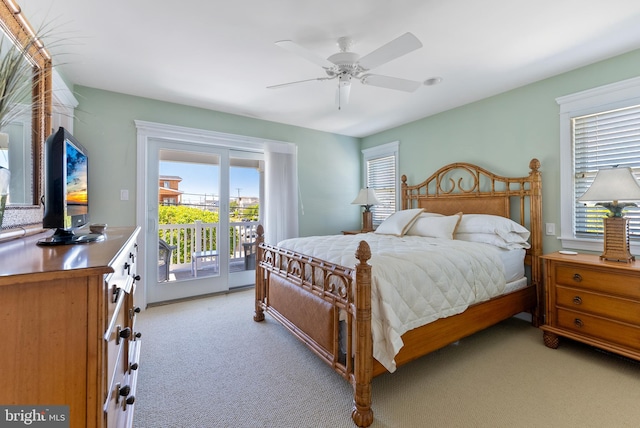 bedroom featuring access to exterior, light colored carpet, and ceiling fan