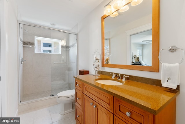 bathroom with tile patterned floors, toilet, a shower with door, and vanity