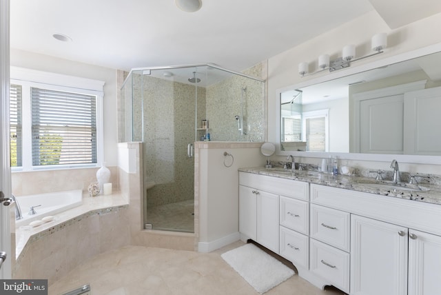 bathroom featuring vanity, a wealth of natural light, and independent shower and bath