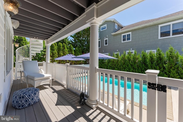 wooden deck featuring a fenced in pool