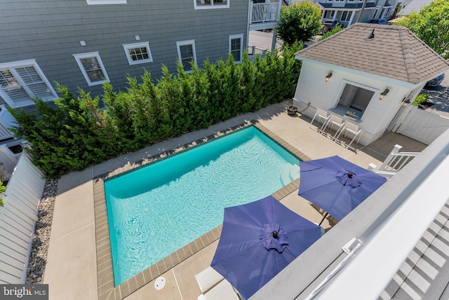 view of pool with a patio area and a bar