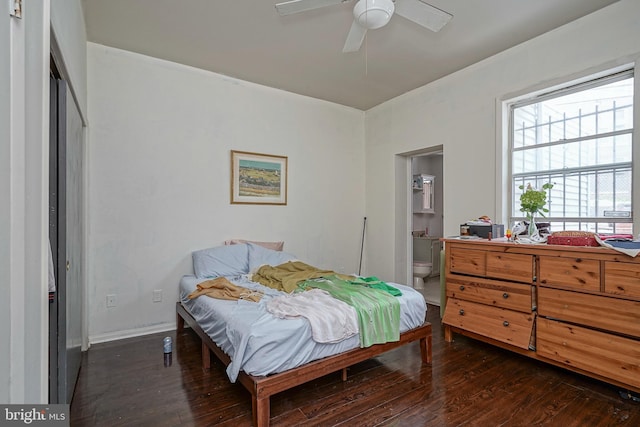 bedroom with dark hardwood / wood-style flooring, ensuite bathroom, and ceiling fan