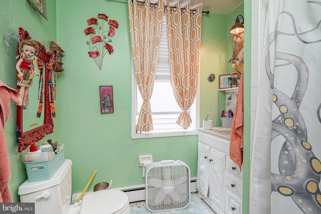 bathroom featuring tile patterned flooring, a baseboard heating unit, vanity, and toilet