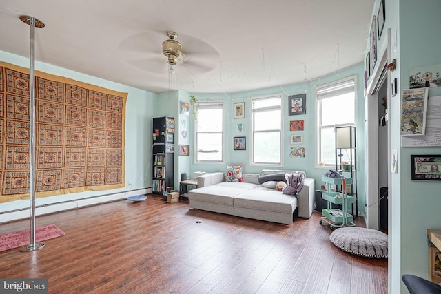 interior space featuring hardwood / wood-style flooring, a baseboard heating unit, and ceiling fan