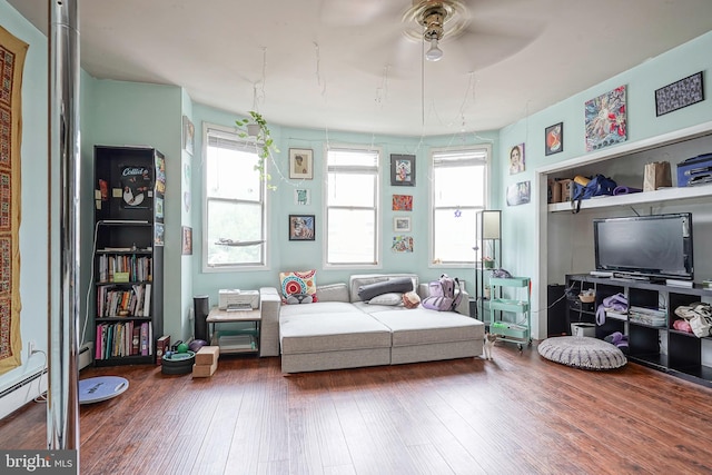 interior space with ceiling fan, baseboard heating, and hardwood / wood-style floors