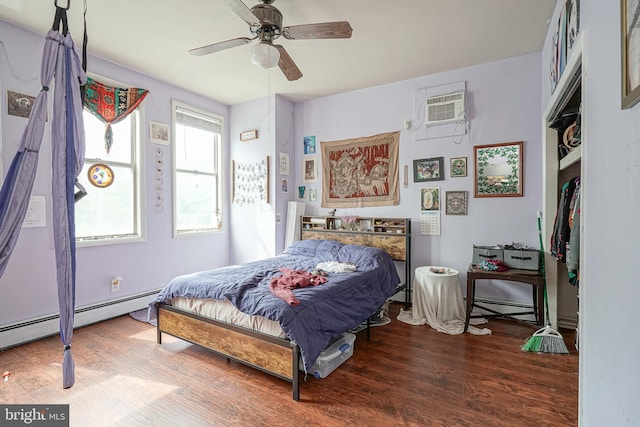 bedroom with ceiling fan, a baseboard heating unit, hardwood / wood-style flooring, and a wall mounted air conditioner