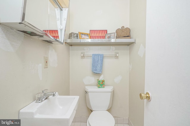 bathroom featuring sink, tile patterned flooring, and toilet