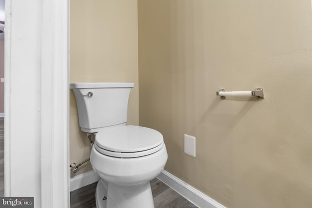 bathroom featuring wood-type flooring and toilet