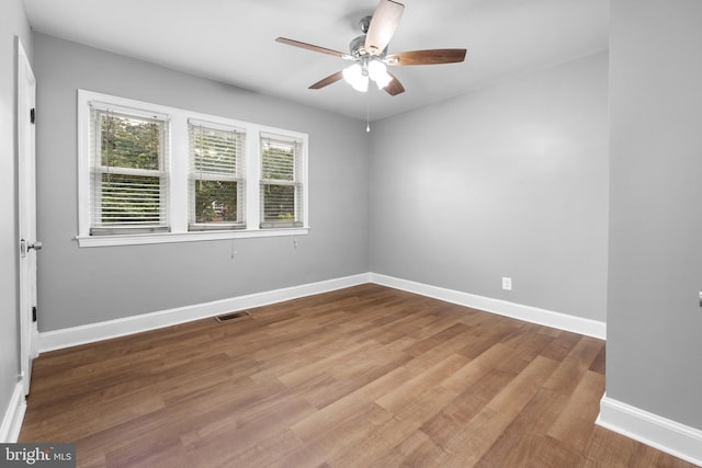 unfurnished room with ceiling fan and wood-type flooring