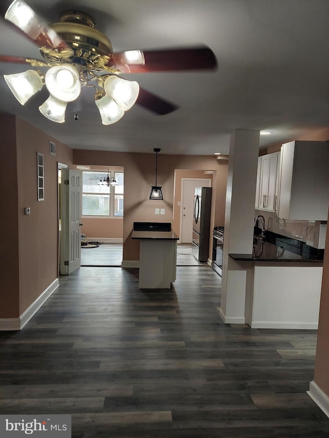 kitchen with decorative light fixtures, appliances with stainless steel finishes, hardwood / wood-style flooring, ceiling fan, and white cabinets