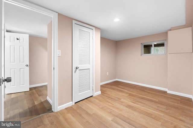 unfurnished bedroom with light wood-type flooring and a closet