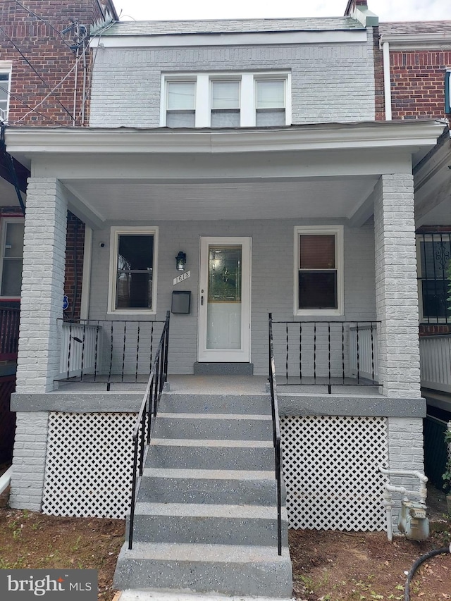 view of property featuring covered porch