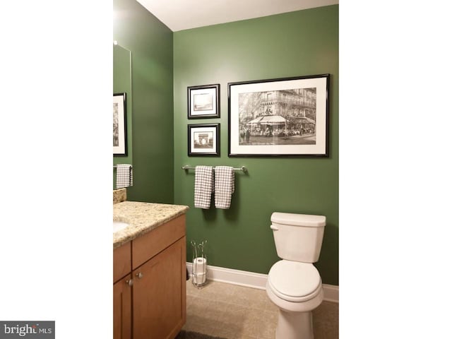 bathroom featuring tile patterned floors, vanity, and toilet