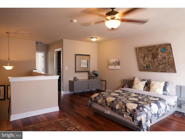 bedroom with ceiling fan and dark hardwood / wood-style floors