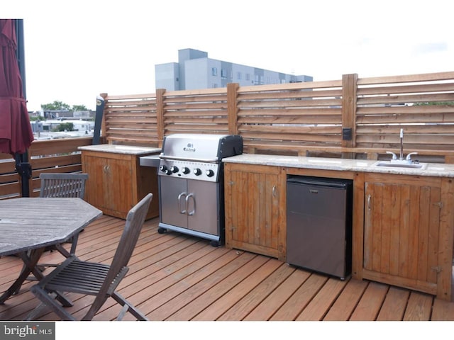 deck featuring sink and area for grilling