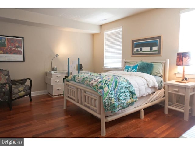 bedroom with dark hardwood / wood-style floors