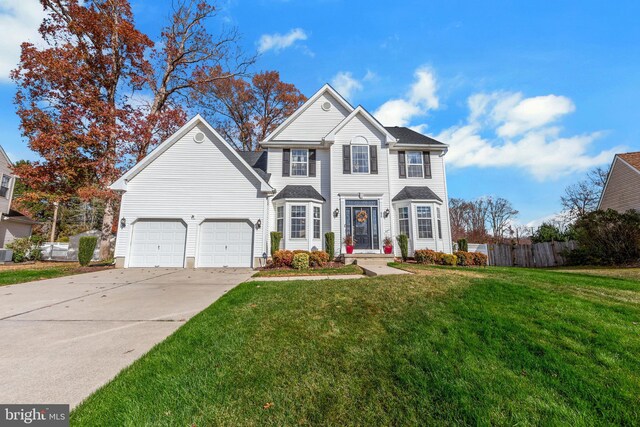 view of front of house with a garage and a front lawn