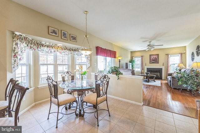 638 Mills Ln, Williamstown, NJ 08094 - dining room with a ceiling fan, baseboards, a glass covered fireplace, and tile patterned floors