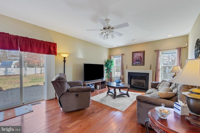 638 Mills Ln, Williamstown, NJ 08094 - living room featuring healthy amount of natural light, hardwood / wood-style floors, ceiling fan, and a fireplace with flush hearth