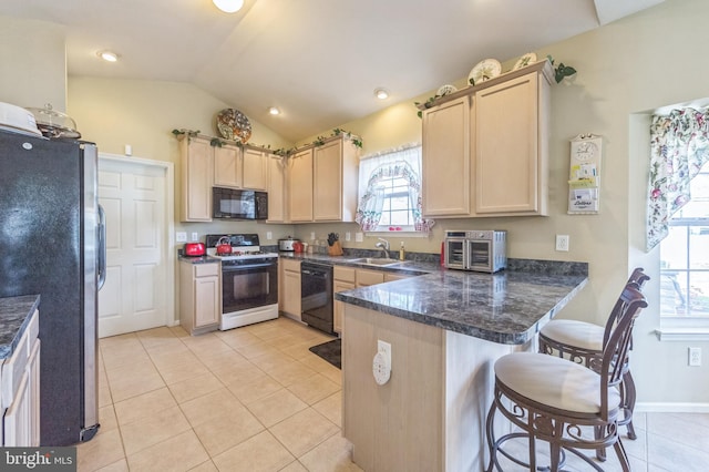 638 Mills Ln, Williamstown, NJ 08094 - kitchen featuring black appliances, light brown cabinets, a sink, a peninsula, and lofted ceiling