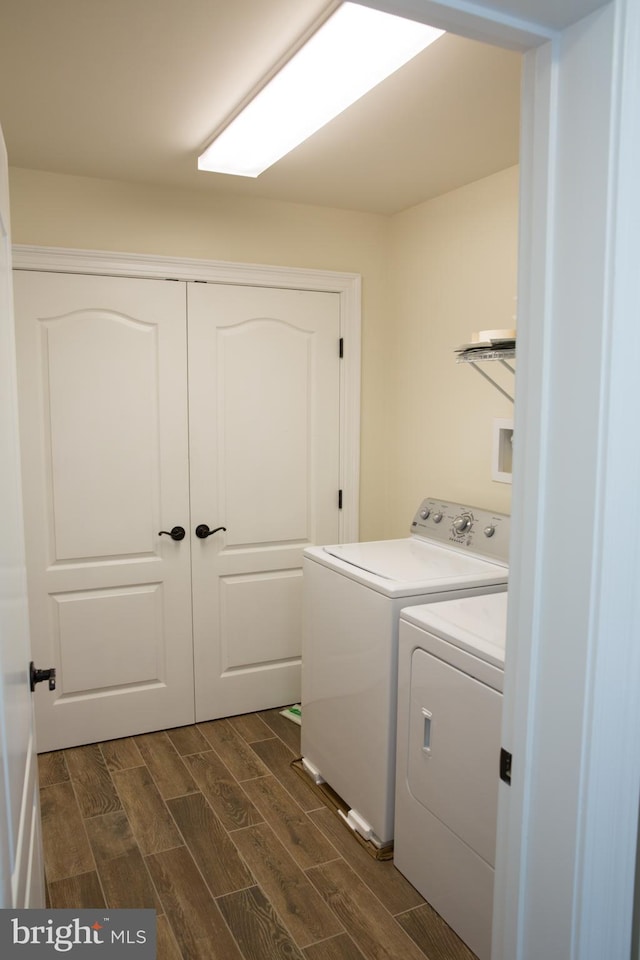 laundry area with washing machine and dryer and dark hardwood / wood-style flooring