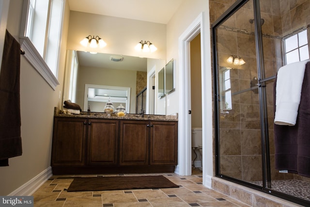 bathroom with a shower with shower door, toilet, tile patterned flooring, and vanity