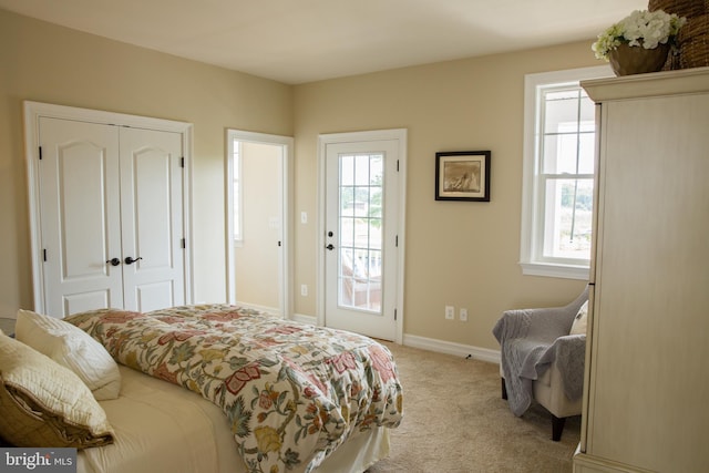 carpeted bedroom featuring a closet and multiple windows