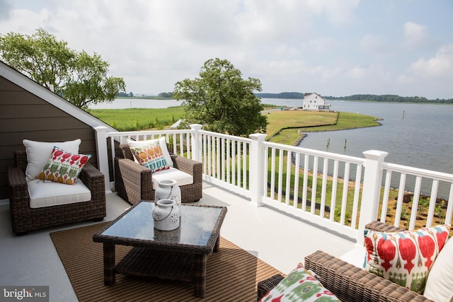 balcony with outdoor lounge area and a water view