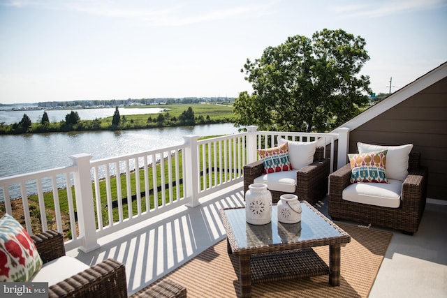 exterior space featuring an outdoor living space and a water view