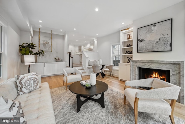 living room with light wood-type flooring and a premium fireplace