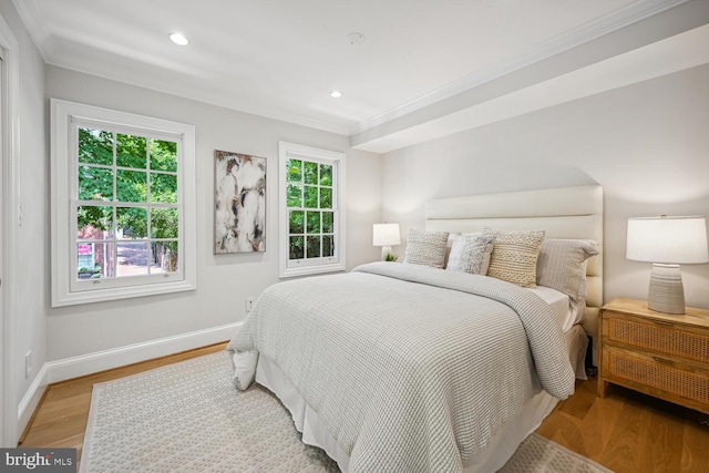 bedroom featuring crown molding and light hardwood / wood-style floors